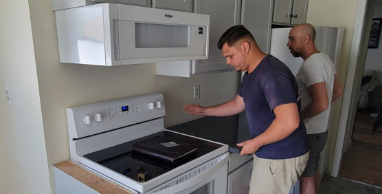 Interstate Custom Kitchen & Bath, Inc team members during a remodel installing a countertop