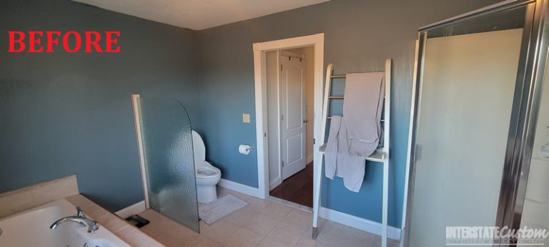 Before image of a bathroom featuring a spacious bathtub, a separate glass-enclosed shower, and a toilet area with a partial frosted glass partition. The room has dark blue walls, beige tile flooring, and white trim around the door.