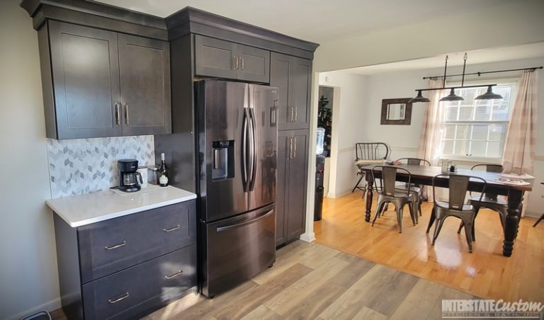 Simply Elegant kitchen remodel showing North Point cabinetry, Hanstone Chantilly lace quartz countertops, and a dining area with a view into the kitchen. Project by Interstate Custom Kitchen & Bath, Inc.