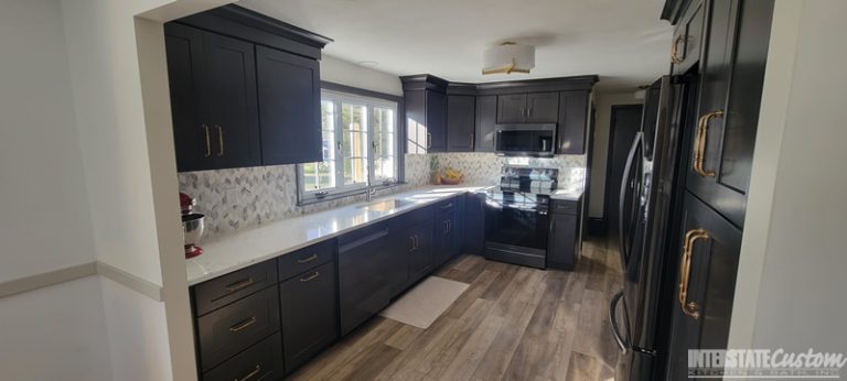 Simply Elegant kitchen remodel with new North Point cabinetry in a shaker style maple slate door, Hanstone Chantilly lace quartz countertops, natural marble braided mosaic tile backsplash, and Jeffery Alexander Tiffany hardware in satin bronze. Project by Interstate Custom Kitchen & Bath, Inc.