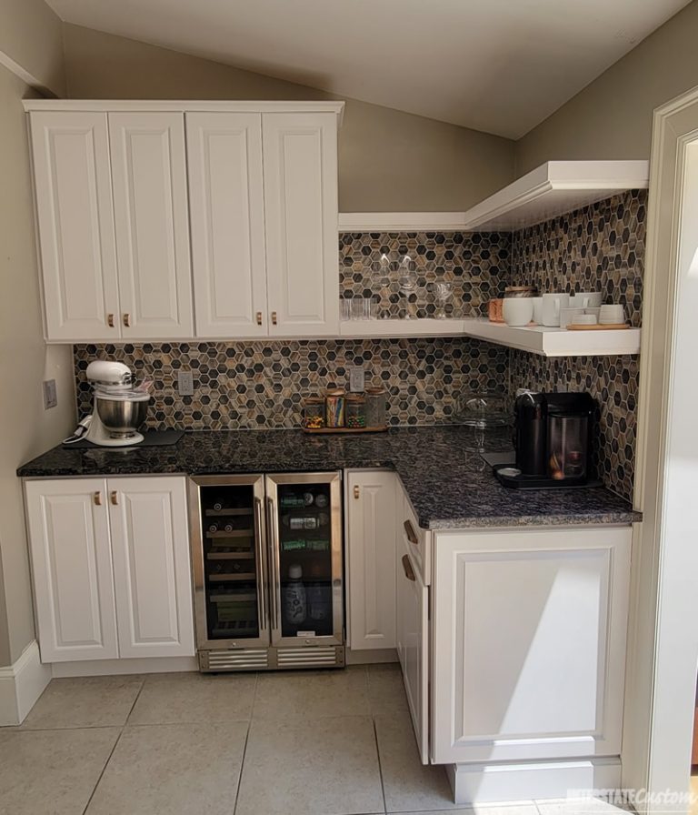 Traditional kitchen with white painted raised panel cabinet doors and open shelves, showcasing sapphire blue granite countertops and a natural stone tile backsplash. Project by Interstate Custom Kitchen & Bath, Inc.