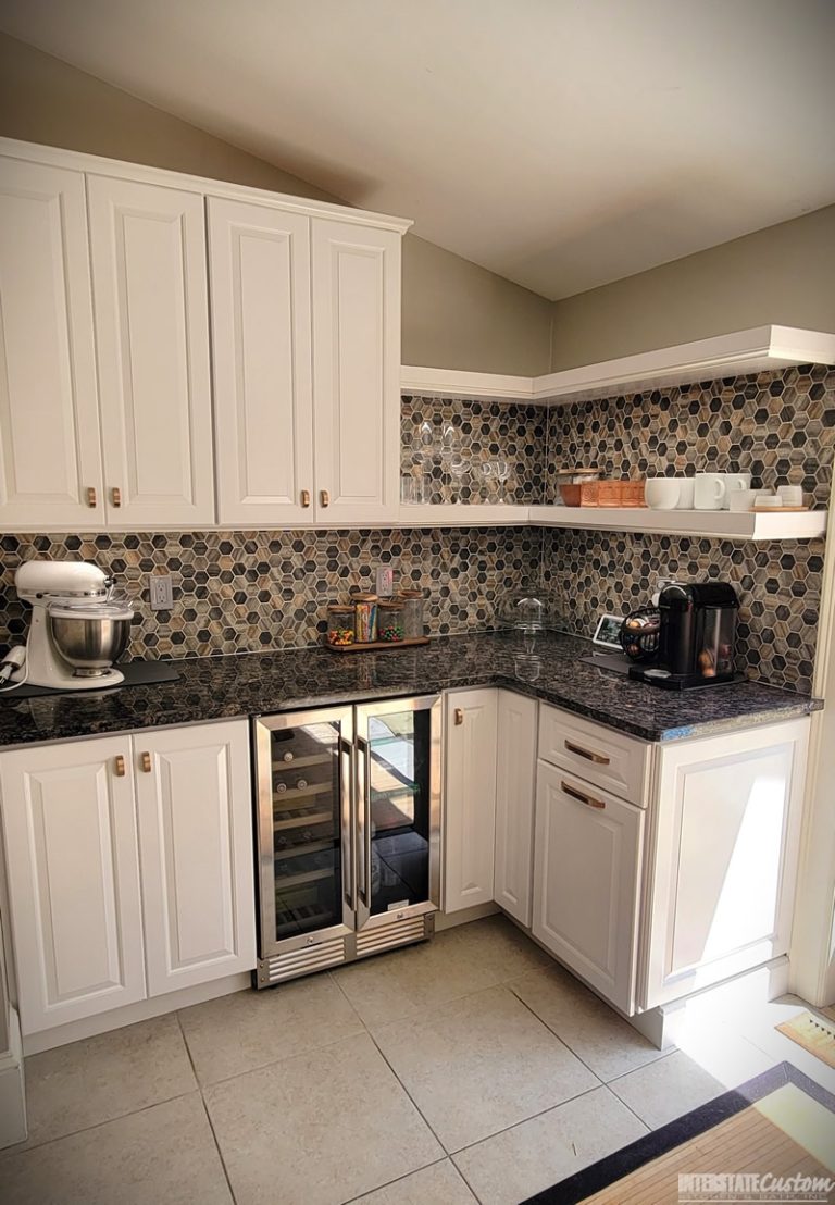 Another angle traditional kitchen with white painted raised panel cabinet doors and open shelves, showcasing sapphire blue granite countertops and a natural stone tile backsplash. Project by Interstate Custom Kitchen & Bath, Inc.