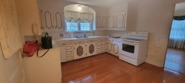 Before kitchen showing dated white cabinetry, electric stove, and original layout in Longmeadow MA