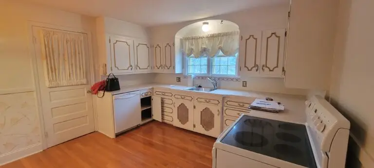 Before kitchen angle with corner cabinets, laminate counters, and window sink wall in Longmeadow MA