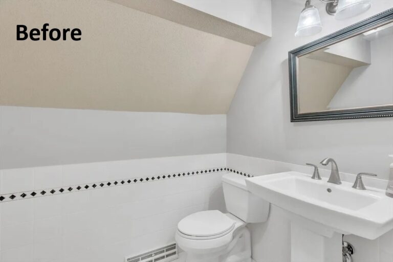 Small bathroom before renovation with pedestal sink, toilet, tiled walls, and sloped ceiling