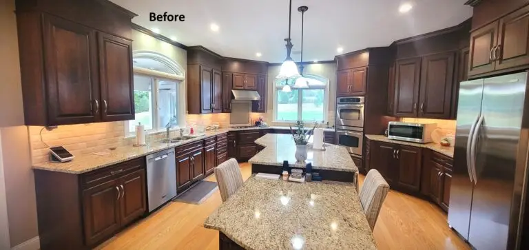 Traditional kitchen before remodel with dark wood cabinets, granite countertops, stainless steel appliances, and center island with seating