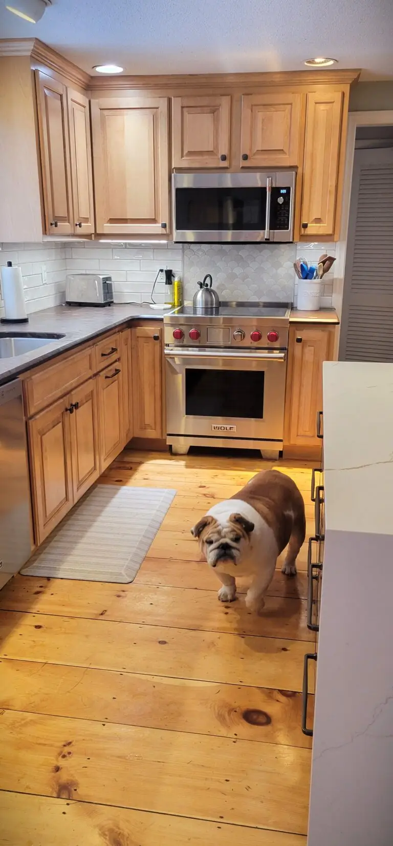 After kitchen with Sable Hickory island, quartz waterfall countertop, and refaced Honey Maple cabinets in East Longmeadow MA