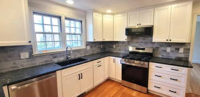 After kitchen showing Polar White cabinets, gray tile backsplash, and farmhouse-style layout in Longmeadow MA