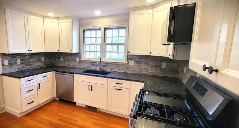 After kitchen sink wall with Blanco Silgranit sink, Symmons faucet, and gray subway tile backsplash
