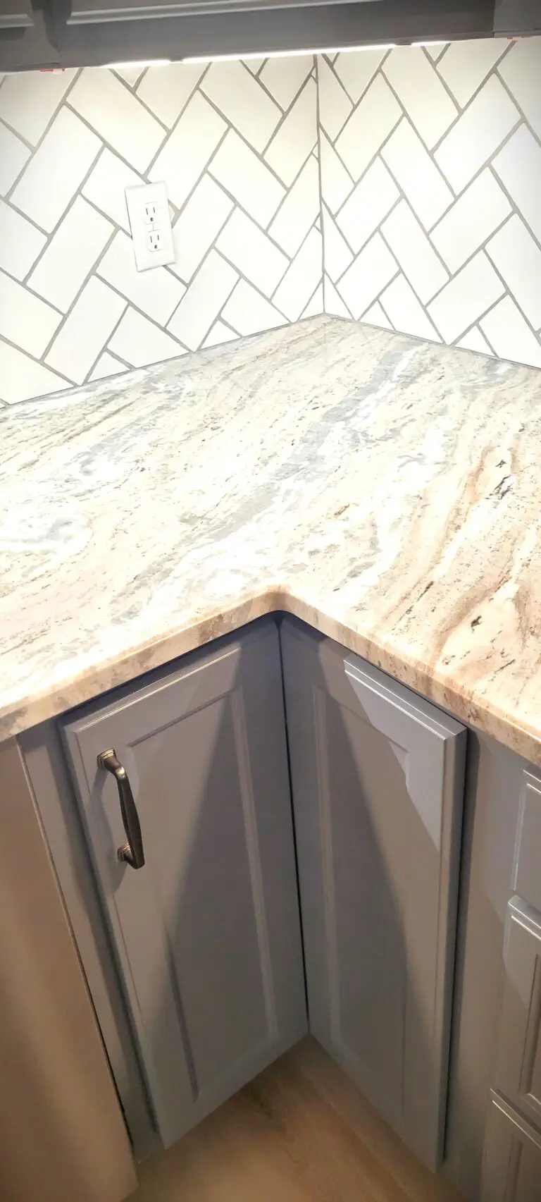 Renovated kitchen with large peninsula, gray shaker cabinets, quartz surfaces, and modern layout